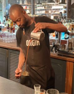 Barista cooling artisan coffee at Origin Coffee Roasting cafe in Cape Town South Africa